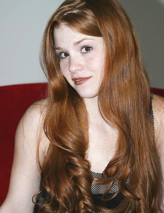 Fair skinned redhead Tiffany shows the pink of her teen pussy up close